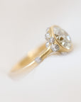 Gold ring with a diamond on a light gray background