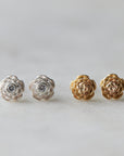 two pairs of rose garden studs- the left pair is silver with diamonds, the right pair is yellow gold with no diamonds.