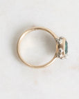 Gold ring with a gemstone on a light gray background