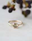 round sage green montana sapphire set in a gold ring with branching prongs