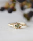 round sage green montana sapphire set in a gold ring with branching prongs