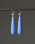 long teardrops of blue common opal hang beneath gold ear wires and roses