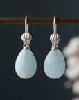teardrops of pale, icy aquamarine hang beneath little silver scallop shell ear wires