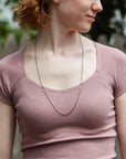Silver and gold egg link necklace on person- Hannah Blount