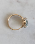 Gold ring with a gemstone on a light gray background