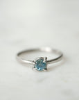 blue montana sapphire stone set in a ring of platinum via prongs.