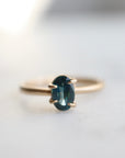 0.66ct Montana Sapphire Vanity Ring set in 14k gold with four prongs. The stone is an ocean blue.