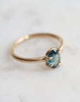 0.66ct Montana Sapphire Vanity Ring set in 14k gold with four prongs. The stone is an ocean blue.