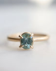 0.83ct Montana sapphire Vanity ring. The pale teal stone is set in 14k yellow gold with four prongs.