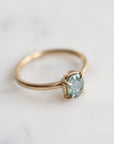 0.83ct Montana sapphire Vanity ring. The pale teal stone is set in 14k yellow gold with four prongs.