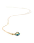 gold necklace with raw opal pendant featuring a gold face against white, by hannah blount
