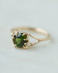 a lush green round tourmaline sits in gold branch prongs in this branch ring. 1/4 view.
