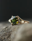 a lush green round tourmaline sits in gold branch prongs in this branch ring. 1/4 view.