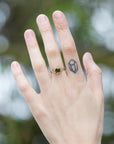 a lush green round tourmaline sits in gold branch prongs in this branch ring. shown on hand