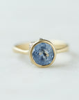 Periwinkle Montana sapphire in yellow gold bezel setting with hand-carved barnacles