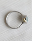 Silver ring with a blue gemstone on a white background