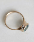 gold ring with blue gemstone, side profile