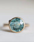 Ring with a blue gemstone on a light background
