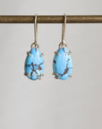 Turquoise earrings on a gray background