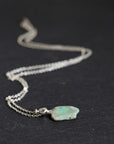 Necklace with an opal pendant on a black background