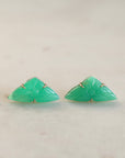 Pair of green triangle-shaped earrings on a light background