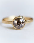 A 1.38ct diamond ring. The diamond has a chestnut hue and is set in 18k gold with an 18k gold band. The setting is encrusted with 14k gold barnacles. The ring is viewed from the front and is on a white background.