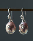 lavender pink pearl earrings with silver barnacles and silver cameo ear wires with faces, by hannah blount
