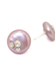 front and side view of pink freshwater button pearl earring studs with silver barnacles by hannah blount jewelry