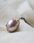 back detail of pink freshwater baroque pearl necklace with gold barnacles and black oxidized silver chain by hannah blount jewelry
