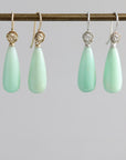 Two pairs of teardrop shaped chrysoprase earrings with rose accents, one pair is 14k yellow gold and the other is in bright sterling silver.