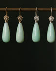 Two pairs of teardrop shaped chrysoprase earrings with rose accents, one pair is 14k yellow gold and the other is in bright sterling silver.