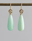 Teardrop shaped chrysoprase earrings with 14k yellow gold rose accents and ear wires.