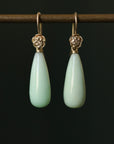 Teardrop shaped chrysoprase earrings with 14k yellow gold rose accents and ear wires.