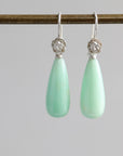 Teardrop shaped chrysoprase earrings with bright sterling silver rose accents and ear wires.