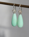 Teardrop shaped chrysoprase earrings with bright sterling silver rose accents and ear wires.