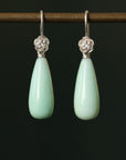 Teardrop shaped chrysoprase earrings with bright sterling silver rose accents and ear wires.