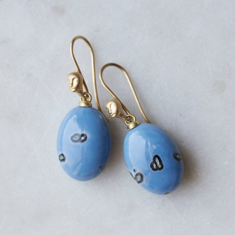 periwinkle blue common opal with mottled black spots. Little Lady faces adorn the gold ear wires.