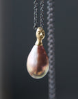 pink freshwater baroque pearl with gold cameo lady face cap and diamond third eye with oxidized black silver chain by hannah blount jewelry