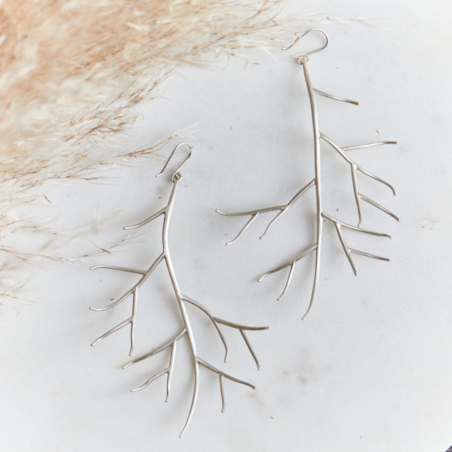 naturalistic branch earrings in silver by hannah blount