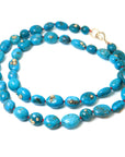 Turquoise beaded necklace with gold barnacles by Hannah Blount