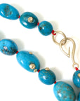 Turquoise beaded necklace with gold barnacles by Hannah Blount