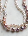 detail of pink and white freshwater baroque pearl necklace in ombre pattern with gold barnacles and fish hook clasp and coral silk by hannah blount jewelry