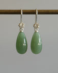 sage green nephrite jade teardrops hang beneath silver rose ear wires