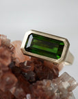 green tourmaline rectangle cut stone ring bezel set in 14k yellow gold with barnacles