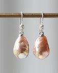 peach freshwater baroque pearl drop earrings with silver ear wires with cameo faces by hannah blount jewelry