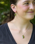 Green gemstone jewelry on woman