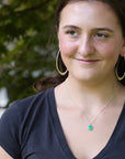Green gemstone necklace on person