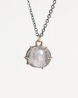 Purple spinel necklace hung from oxidized chain with gold prongs