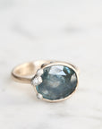 Ring with a large blue gemstone on a light background