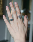 Hand with a ring and tattoo on a blurred background